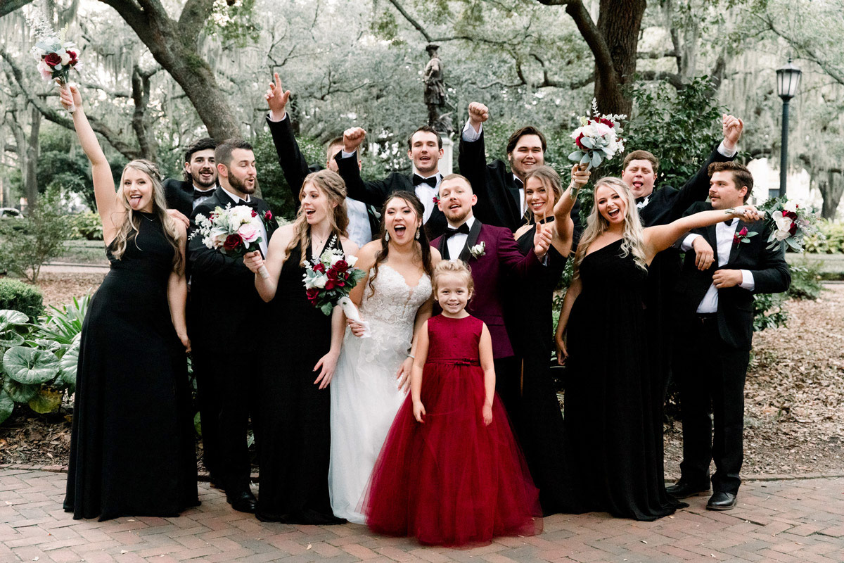 Bride and groom celebrating with the wedding party