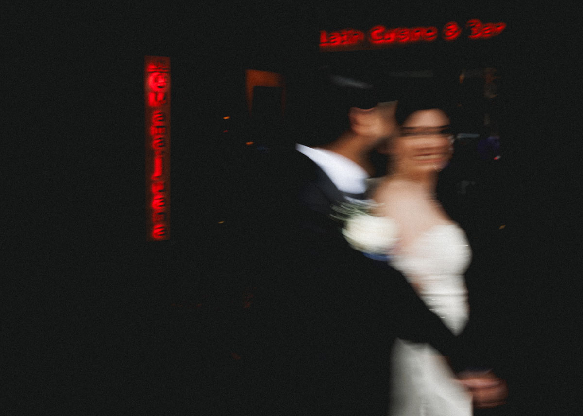 A motion blur shot of a bride and groom walking down a Houston downtown street