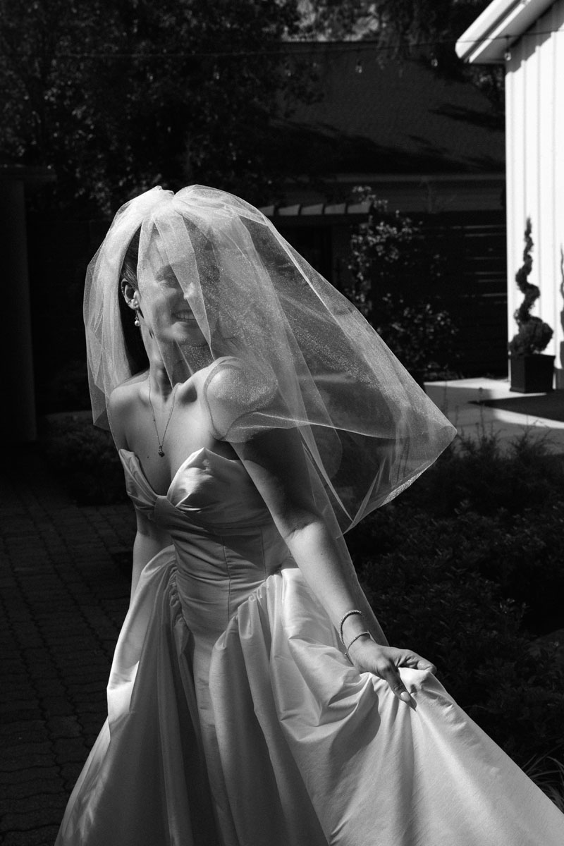 A black and white photograph of a bride at the Vale, Conroe