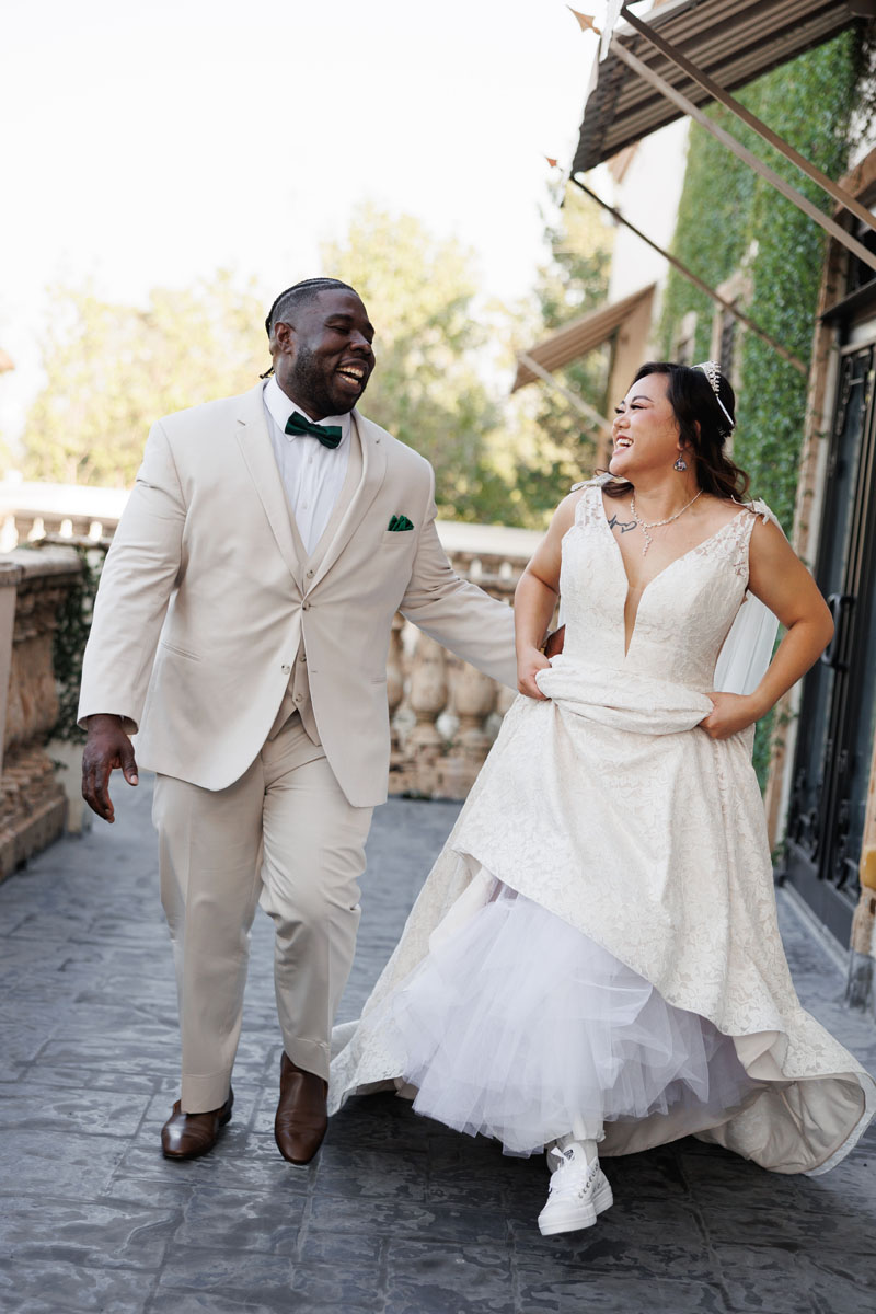 A bride and groom running and laughing