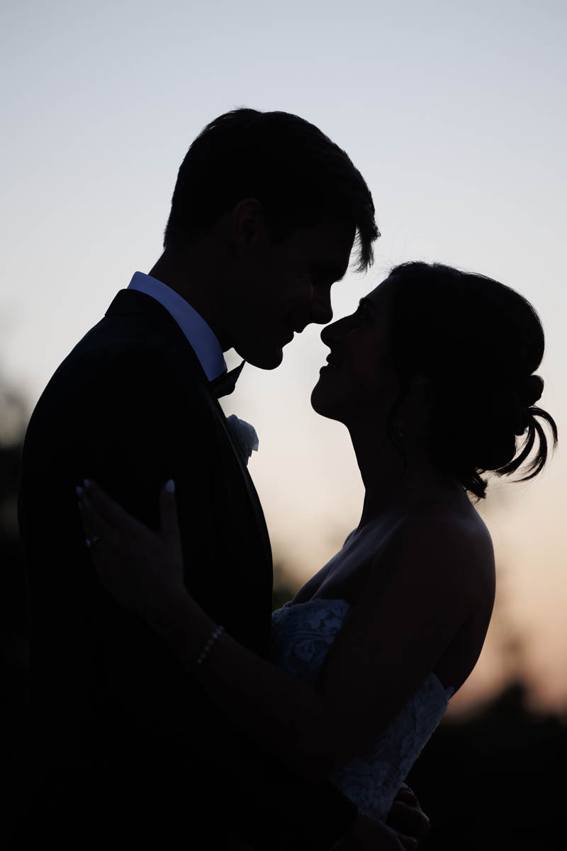 A silhouetted wedding portrait at sunset
