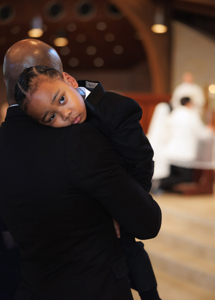 A young guest is sleepy during a church wedding ceremony