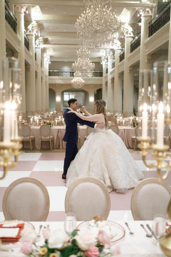 The bride and groom practice their first dance
