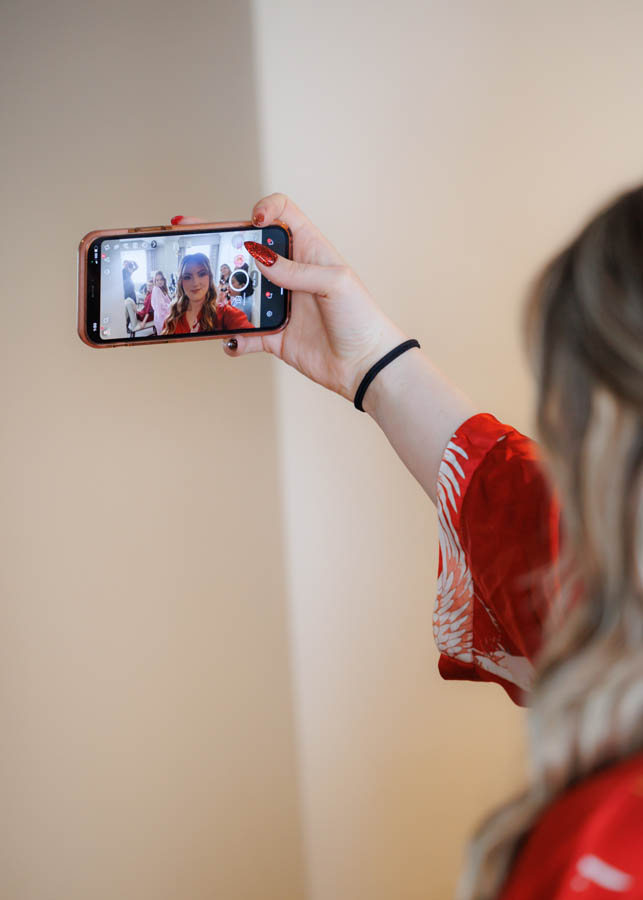 The bride takes a selfie with bridesmaids