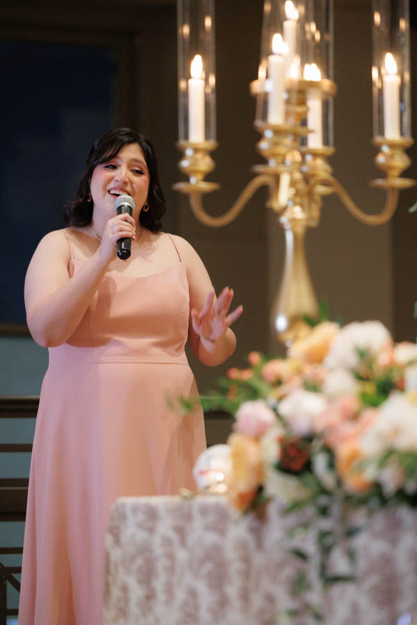 The maid of honor sings for guests
