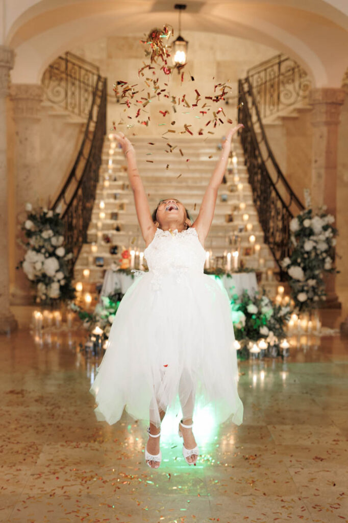 A girl throws confetti at a wedding at Bell Tower on 34th, Houston