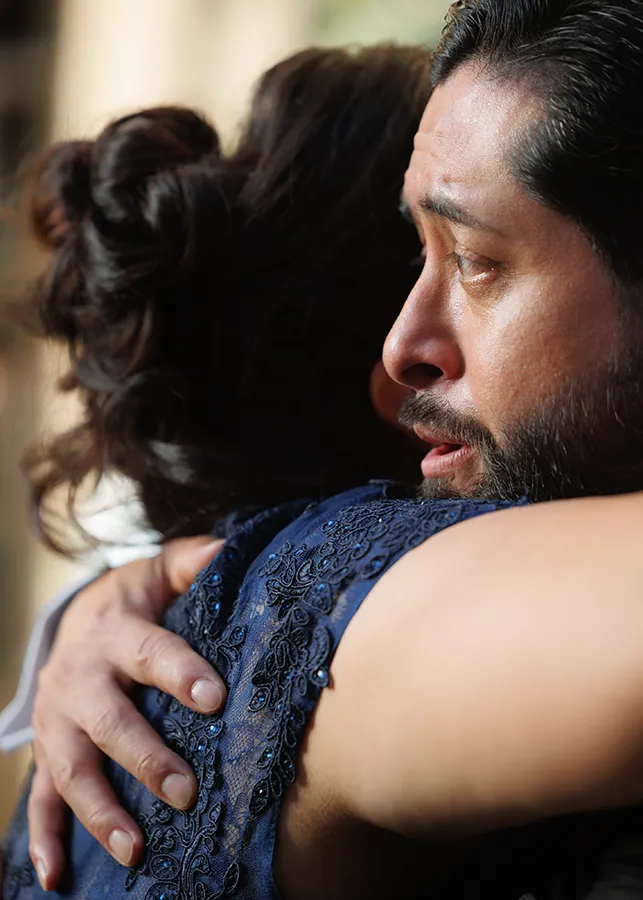 A groom in Houston, Texas cries as he embraces his mother at his wedding