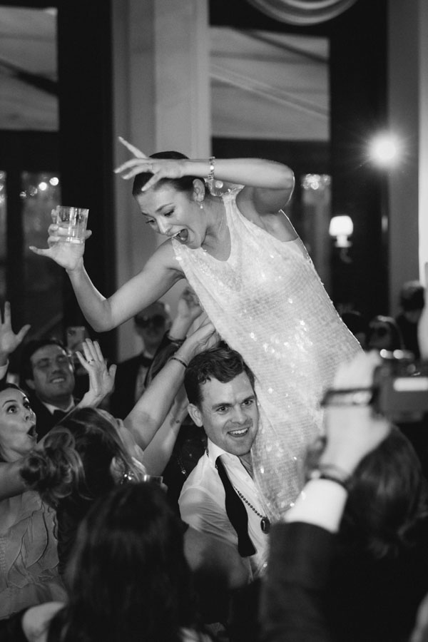 A bride lifted high into the air on the dance floor at her River Oaks Country Club wedding in Houston, Texas