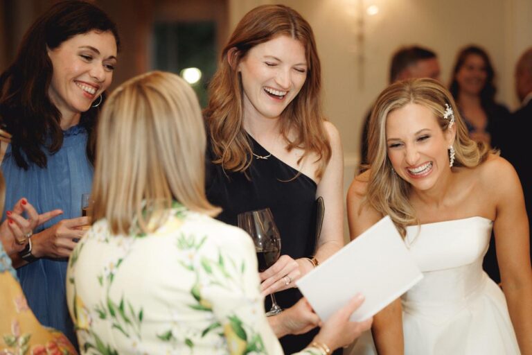 A bride-to-be laughs with guests at her wedding rehearsal dinner at Brennan's of Houston