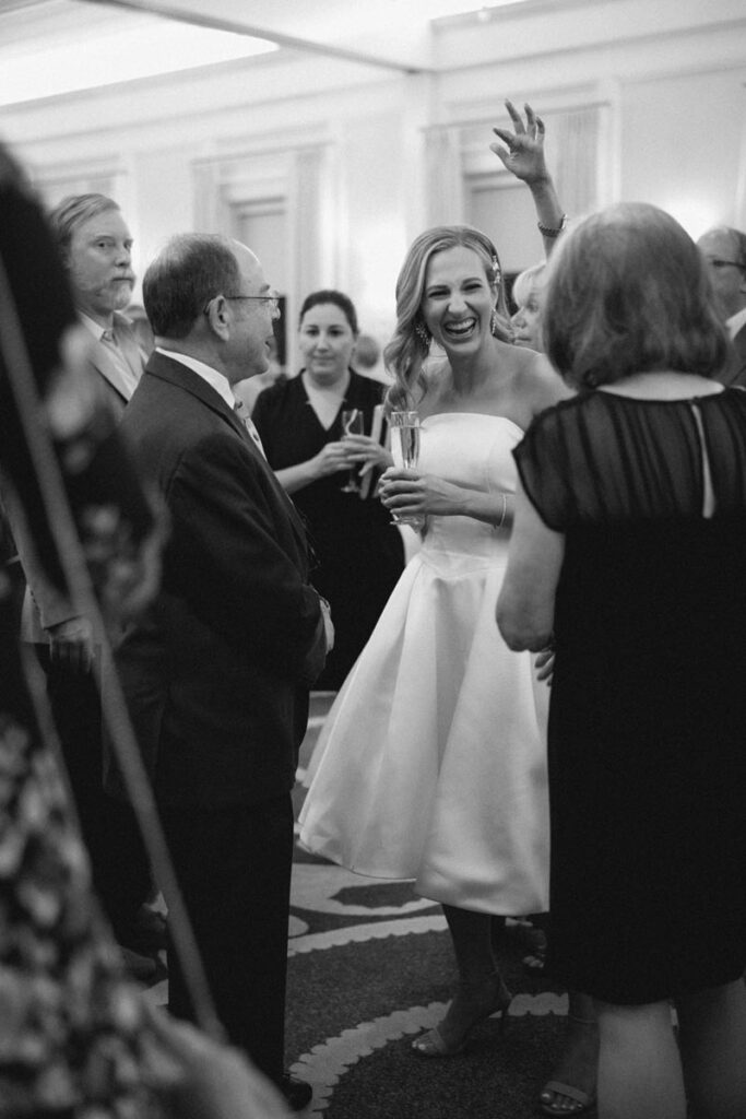 A bride to be laughs with guests at her wedding rehearsal dinner at Brennan's of Houston