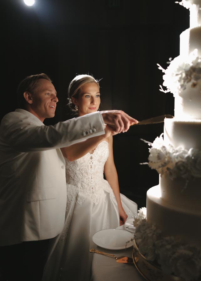 A Post Oak Hotel bride and groom cut the cake at their wedding