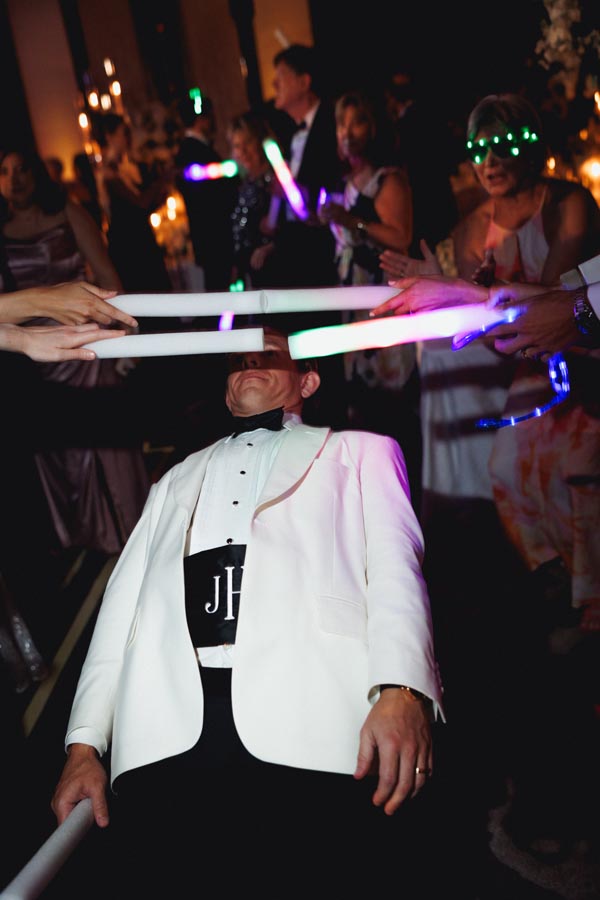 The groom limbos at the reception in the Post Oak ballroom