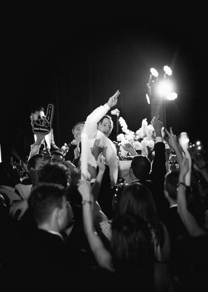 The groom lifted into the air on his wedding day at The Post Oak Hotel