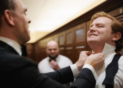 The groom has his shirt collar buttoned