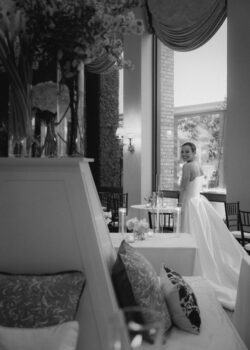 A bride views the beautifully designed reception space at her River Oaks Country Club wedding in Houston