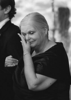 Mother of the groom cries before her son is married at the Church of St. John the Divine in River Oaks