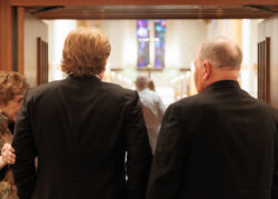 The groom waits to enter the church