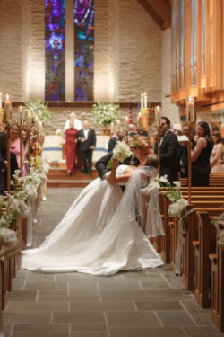 The groom dip kisses the bride at The Church of St. John the Divine, Houston