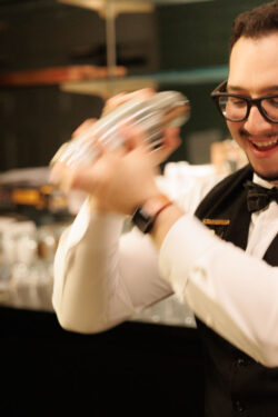 A barman mixes a custom cocktail