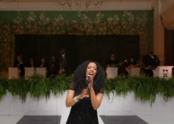 A singer from Jordan Kahn Orchestra on the dance floor at a River Oaks Country Club wedding