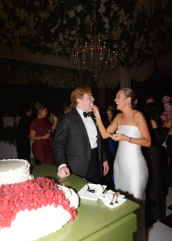 The bride feeds the cake to the groom