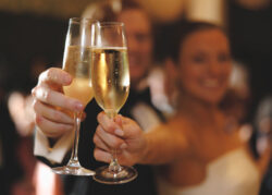 The bride and groom raise their champagne