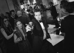 Wedding guests continue a conga line through the room at River Oaks Country Club