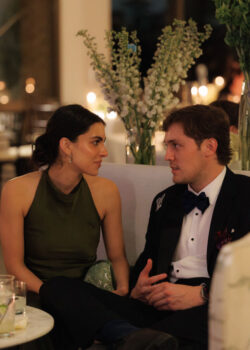 Guests in conversation at a luxury black tie wedding