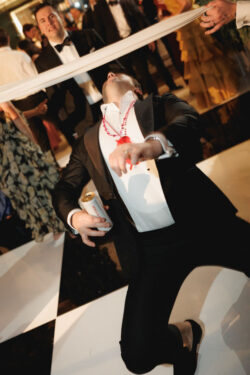 A guest limbos on the dance floor at a River Oaks Country Club wedding