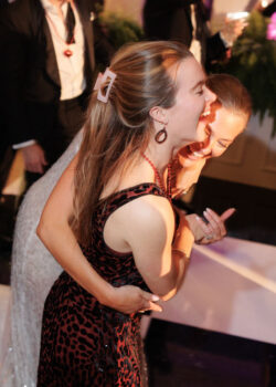 The bride laughs with a guest