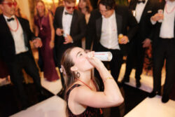 A guest drinks on the dance floor