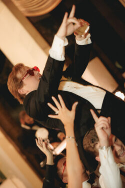 The groom is lifted by groomsmen