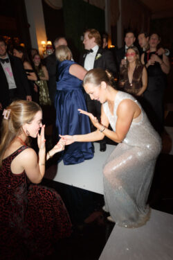A guest admires the bride's ring on the dancefloor