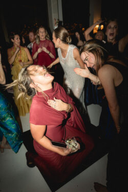A modern, direct flash dancefloor shot as guests dance at a wedding reception at River Oaks Country Club, Houston Texas