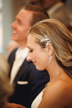 A bride and groom listen to toasts at a Brennan's of Houston wedding rehearsal dinner