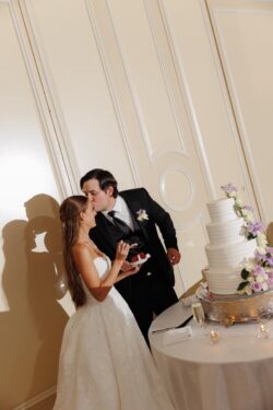 The bride and groom with the cake at a Houstonian Club wedding in Houston Texas