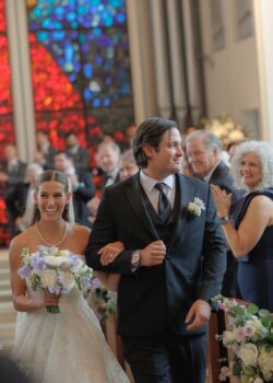 A wedding photograph of the bride and groom leaving the ceremony