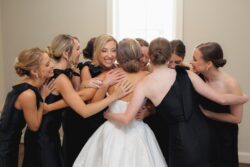 Bridesmaids hug the bride in River Oaks before her Houston, Texas wedding