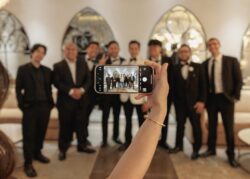 A Le Tesserare wedding in Houston, the groom's party are photographed by a guest with a phone